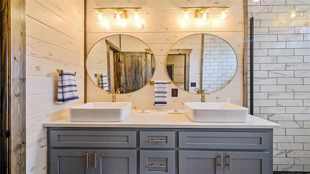 bathroom with vanity, wood walls, and walk in shower