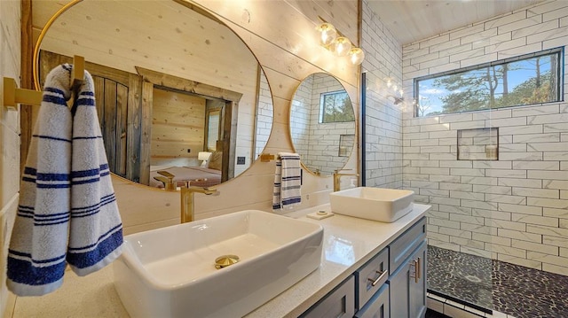 bathroom featuring vanity and tiled shower