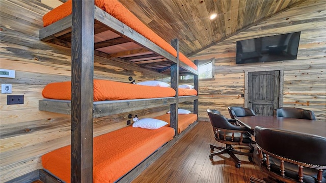 interior space with dark hardwood / wood-style flooring, lofted ceiling with beams, wood ceiling, and wood walls