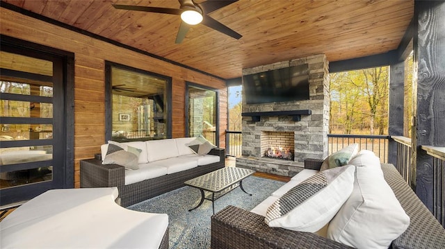 exterior space with ceiling fan, wood ceiling, and an outdoor stone fireplace