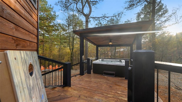 wooden deck with a hot tub