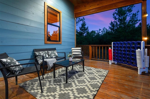 deck at dusk featuring outdoor lounge area