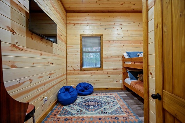 sitting room with wood walls and dark hardwood / wood-style flooring