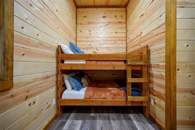 unfurnished bedroom featuring dark hardwood / wood-style flooring, wooden walls, and wood ceiling