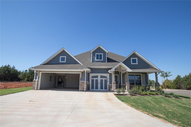 craftsman-style home with a porch, a carport, and a front lawn