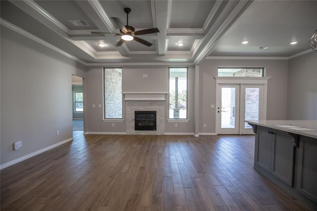 unfurnished living room featuring coffered ceiling, ceiling fan, ornamental molding, beam ceiling, and dark hardwood / wood-style flooring