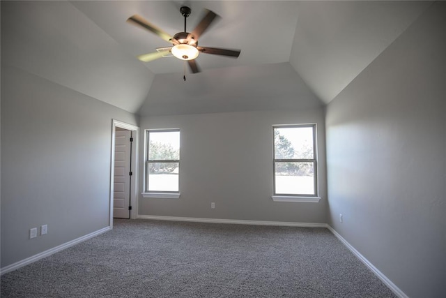 spare room with carpet floors, vaulted ceiling, and ceiling fan