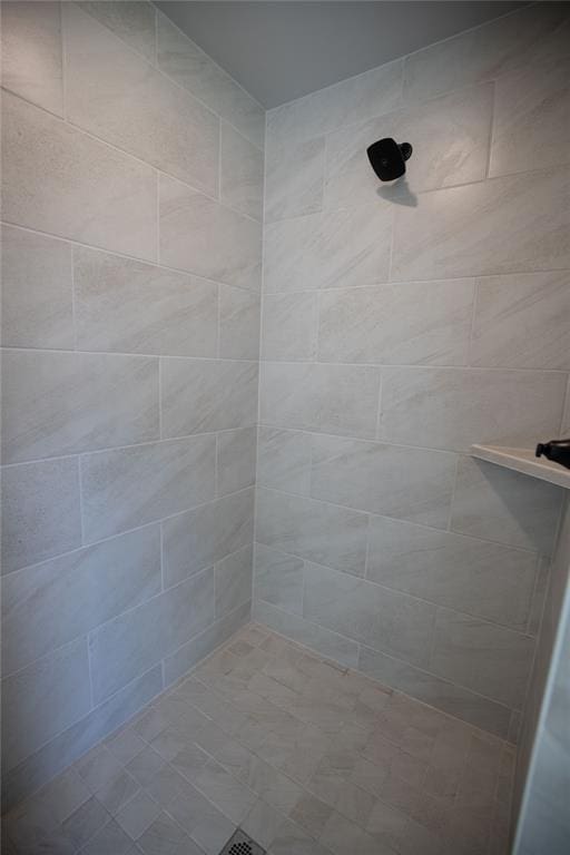 bathroom with tiled shower