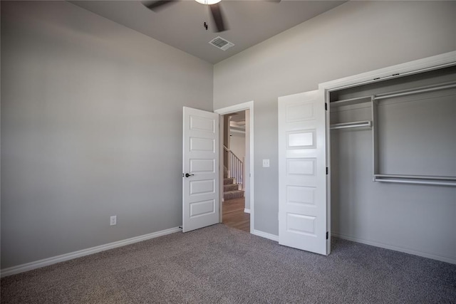 unfurnished bedroom featuring carpet flooring, ceiling fan, and a closet