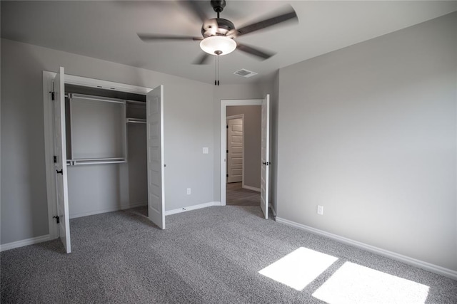 unfurnished bedroom featuring ceiling fan, a closet, and dark carpet