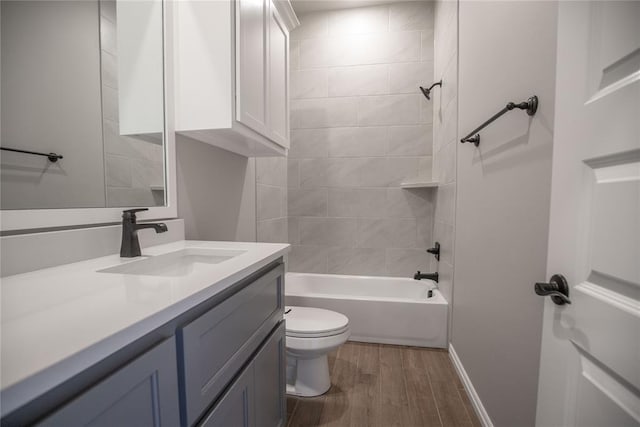 full bathroom featuring toilet, hardwood / wood-style floors, vanity, and tiled shower / bath