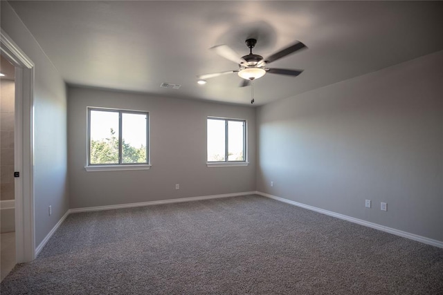 spare room featuring carpet and ceiling fan