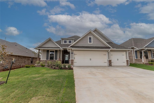 craftsman house with a garage and a front lawn