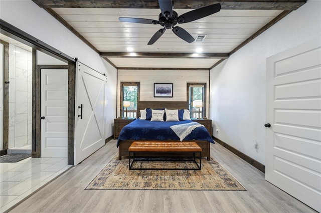 bedroom with a barn door, ceiling fan, light hardwood / wood-style floors, and wooden ceiling