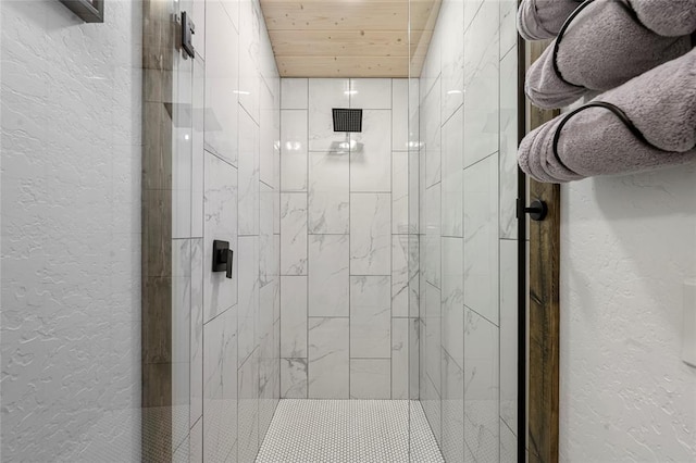 bathroom with a shower with door