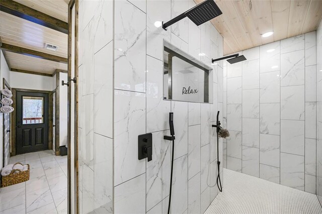 bathroom featuring a tile shower and wood ceiling