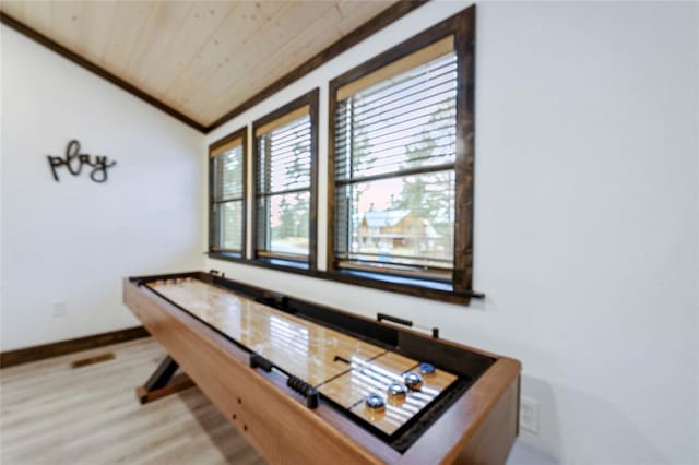 interior space with crown molding, wooden ceiling, vaulted ceiling, and hardwood / wood-style flooring