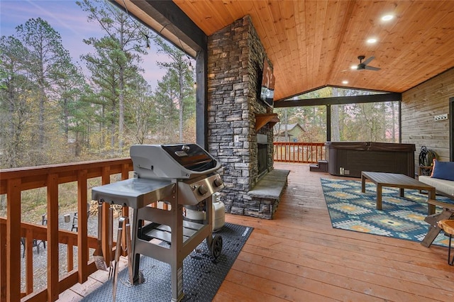 deck at dusk with ceiling fan and a hot tub