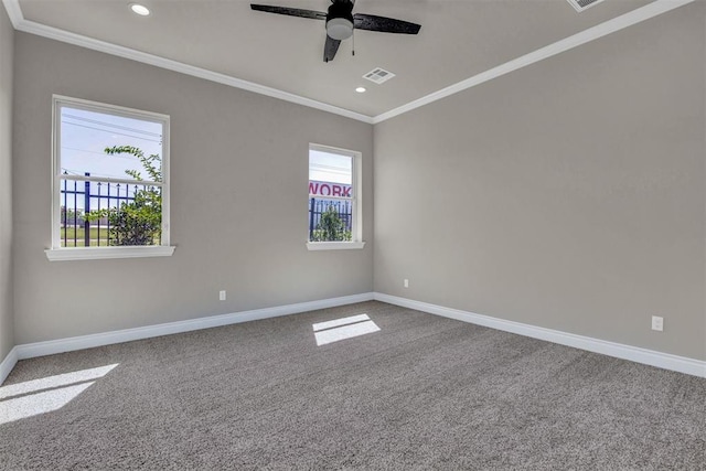 carpeted spare room with ceiling fan and crown molding