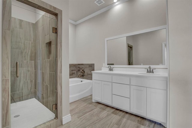 bathroom featuring plus walk in shower, vanity, and ornamental molding