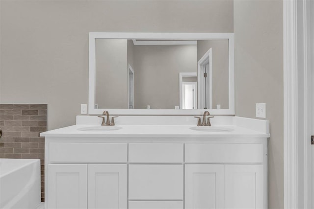 bathroom featuring a washtub, vanity, and tile walls