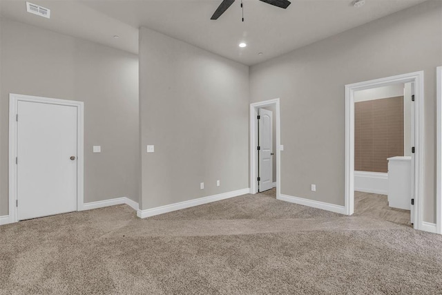 spare room with ceiling fan and light colored carpet