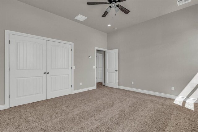 unfurnished bedroom with carpet floors, a closet, and ceiling fan