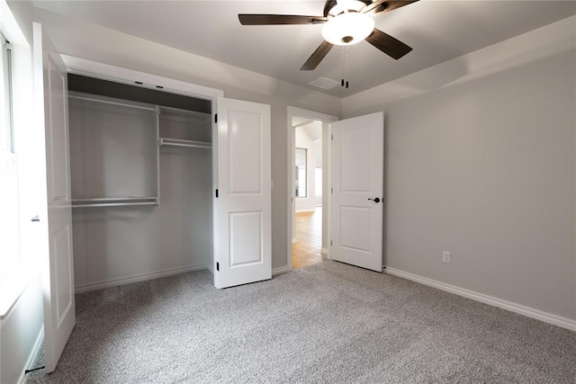 unfurnished bedroom featuring light carpet, ceiling fan, and a closet