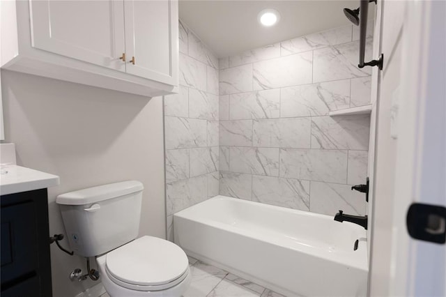 full bathroom with tiled shower / bath, vanity, and toilet