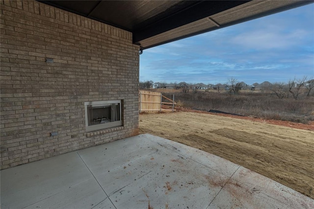 view of patio with an outdoor brick fireplace