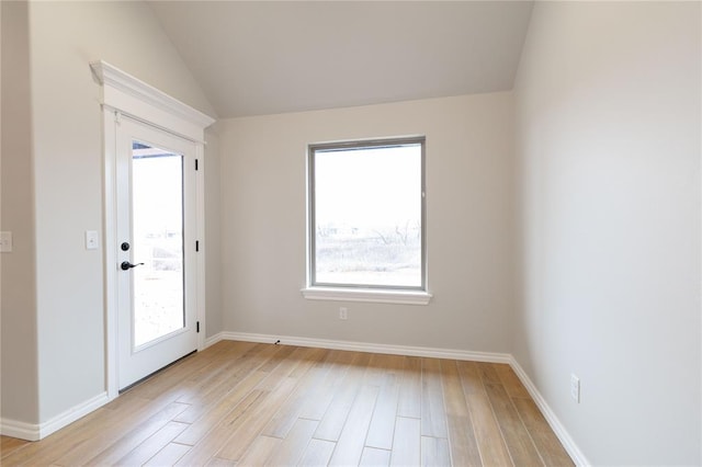 unfurnished room featuring vaulted ceiling and light wood-type flooring