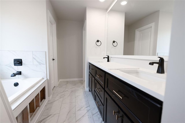 bathroom featuring vanity and a washtub