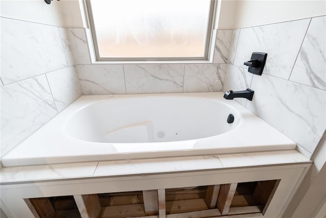 bathroom with a relaxing tiled tub