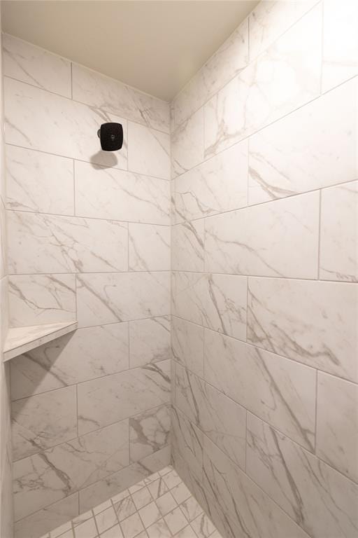 bathroom with tiled shower