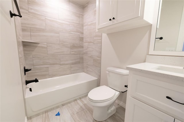 full bathroom featuring tiled shower / bath, vanity, and toilet