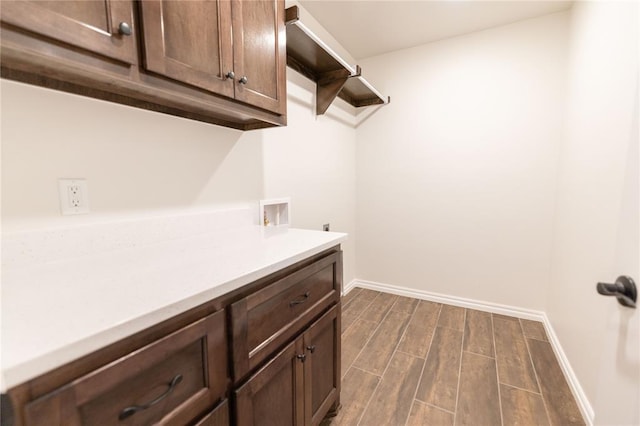 clothes washing area featuring cabinets, hookup for a washing machine, and electric dryer hookup