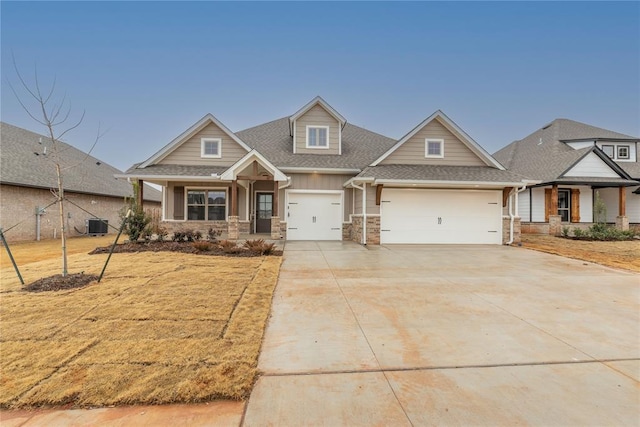 craftsman-style home with central AC, a garage, and covered porch