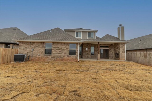 rear view of house with cooling unit and a patio area