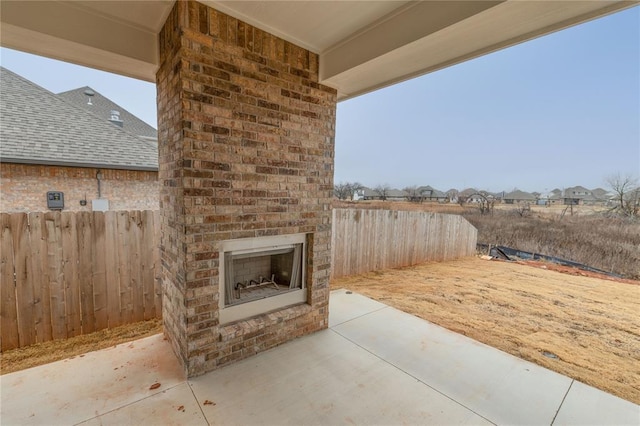 view of patio / terrace featuring an outdoor brick fireplace