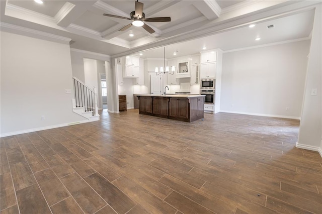 unfurnished living room with beamed ceiling, coffered ceiling, dark hardwood / wood-style floors, and ceiling fan