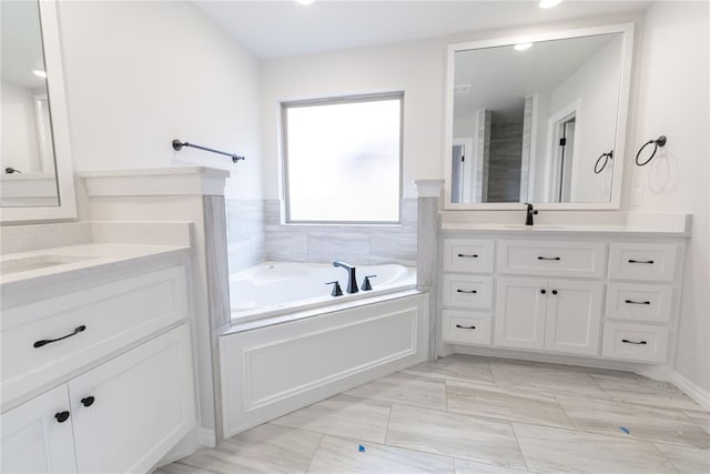 bathroom with a tub to relax in and vanity