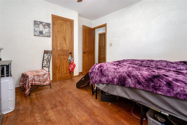 bedroom featuring ceiling fan and hardwood / wood-style floors