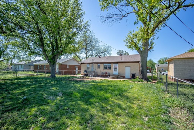 rear view of house with a yard