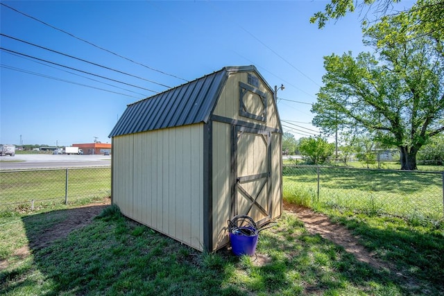 view of outbuilding featuring a lawn