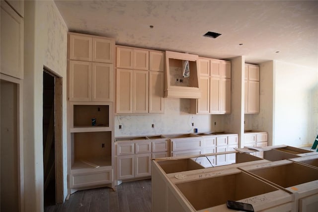 kitchen featuring a center island, dark hardwood / wood-style floors, and cream cabinetry