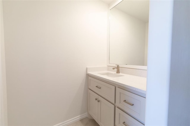 bathroom with vanity and baseboards