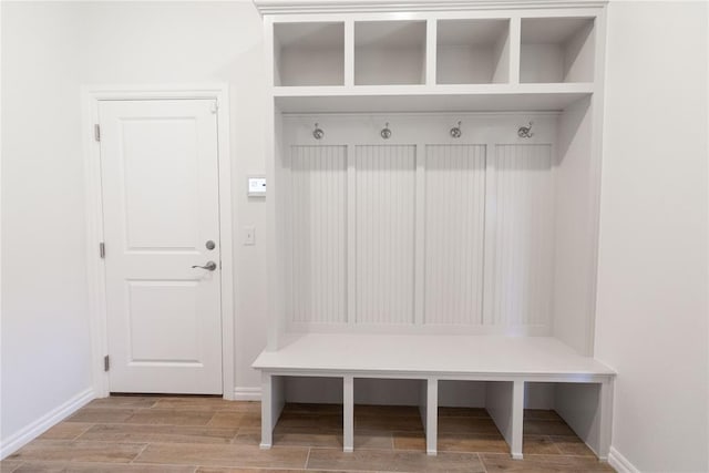 mudroom with baseboards and wood tiled floor