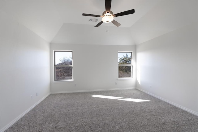 carpeted empty room with vaulted ceiling, a wealth of natural light, and ceiling fan