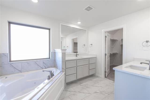 bathroom featuring vanity and a bath