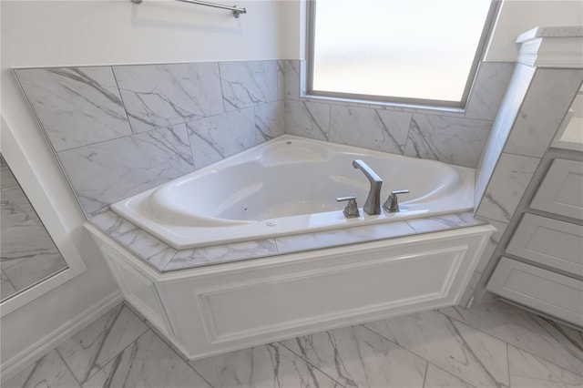 bathroom with a washtub and vanity